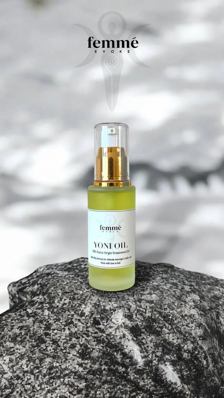 Femme Evoke Yoni Oil bottle on a warm neutral background